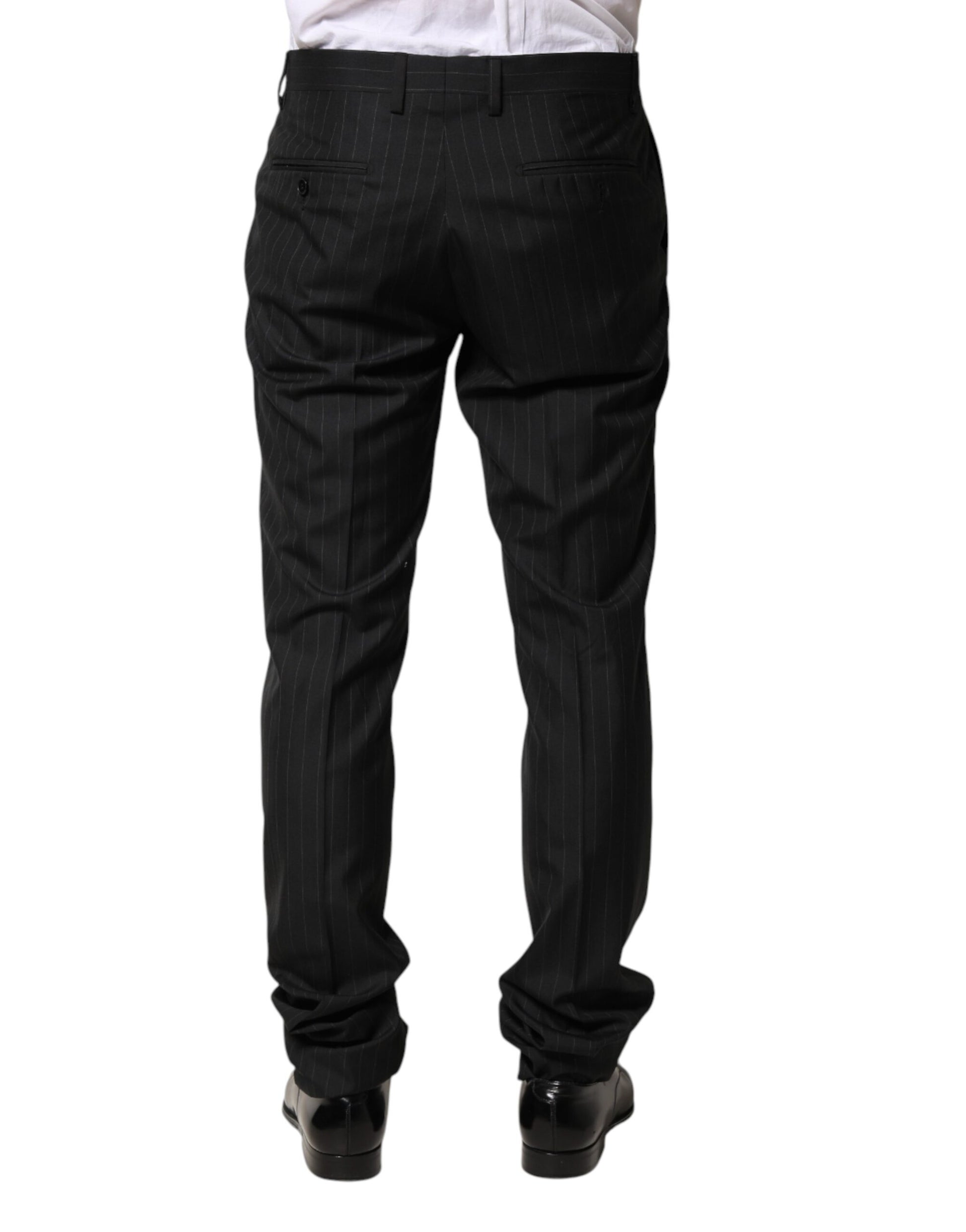 A pair of black wool trousers with stripe pattern, designed for men. They are part of the Dolce & Gabbana bra