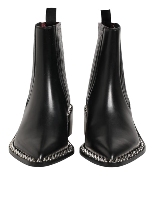 Pair of black leather boots with silver studs on sides