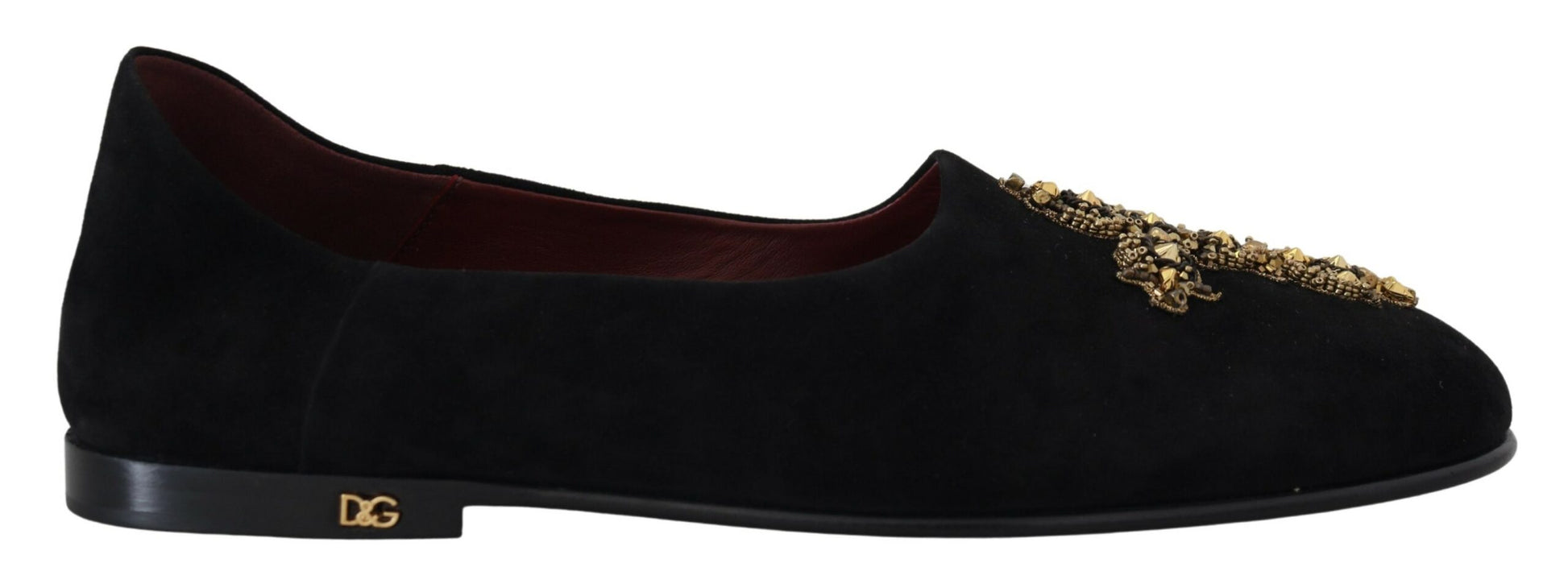 Pair of black dress shoes with gold accents and a small heel