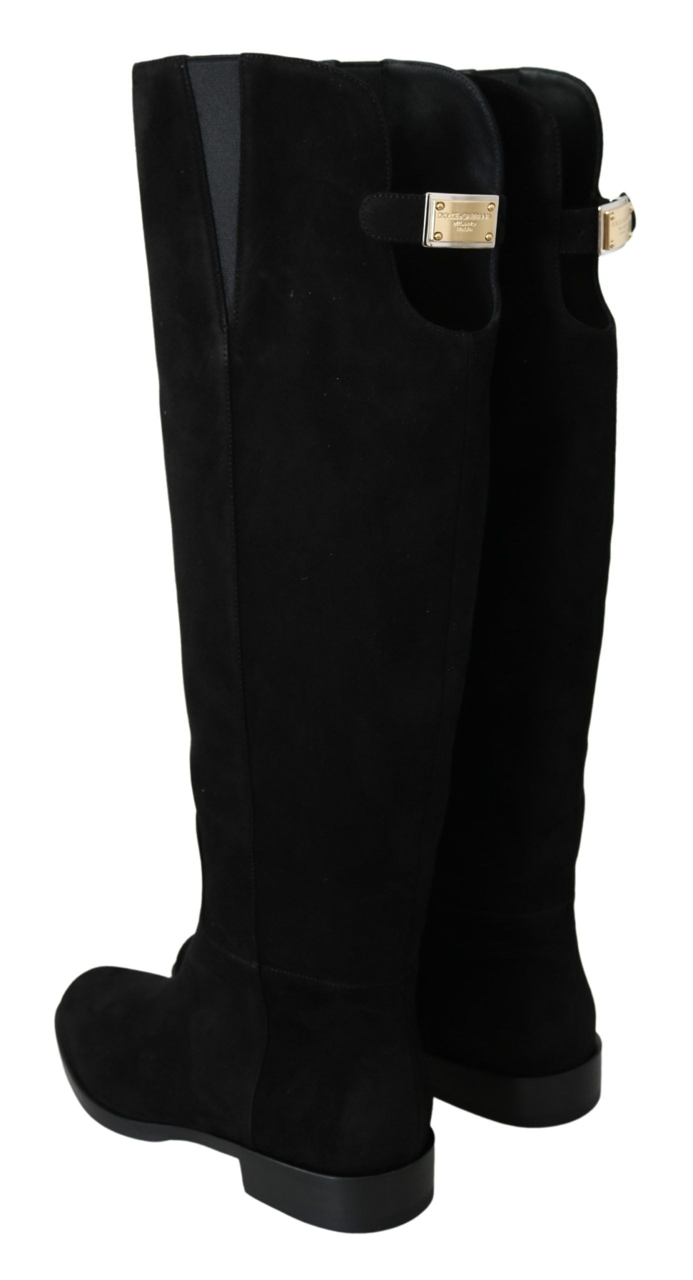 Pair of black knee high boots with a heel