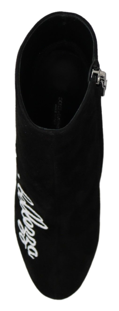 Pair of black slippers with white lettering on side