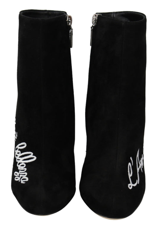 Pair of black velvet boots with white embroidery on top