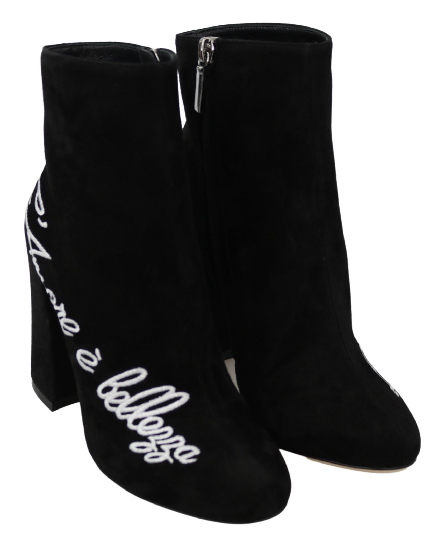 Pair of black suede boots with white lettering on side