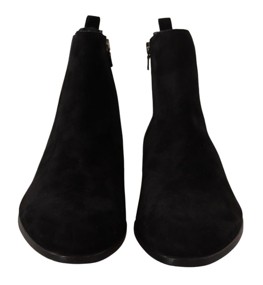 Pair of black knee high boots with elastic panels and a zipper on top