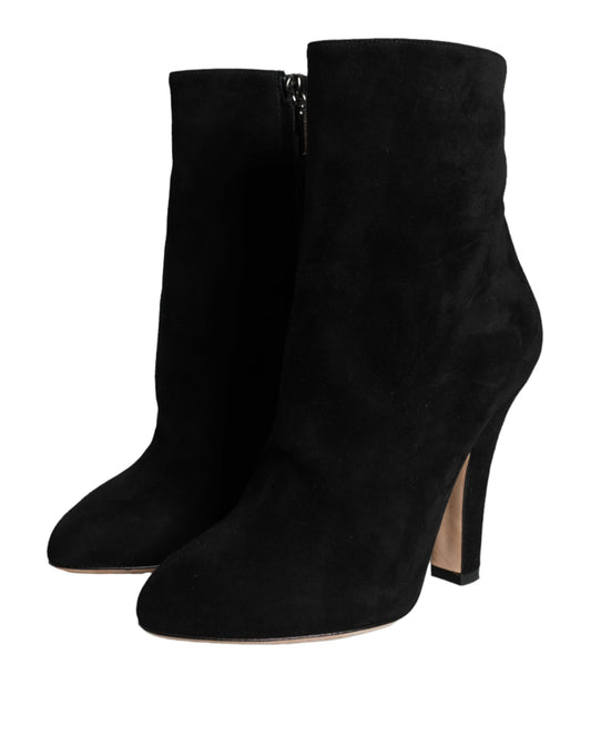 Pair of black suede boots with heels