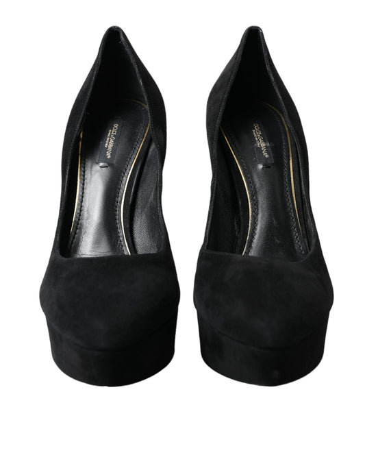 Pair of black high heel shoes with gold accents