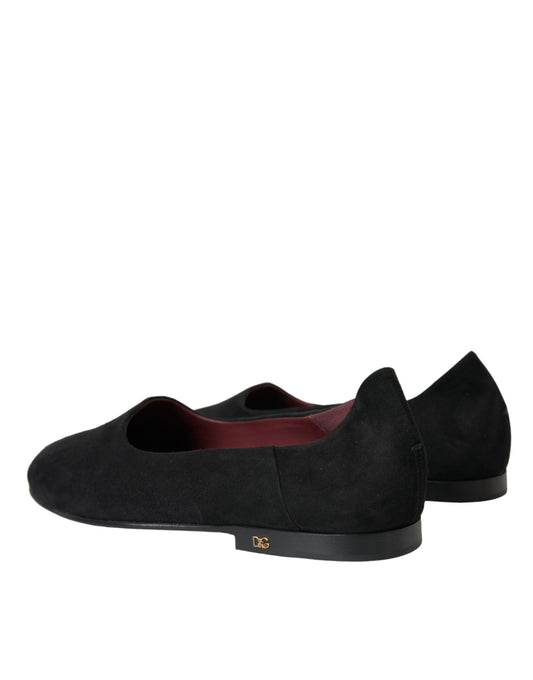 Pair of black loafers with red trim and a small logo on the side