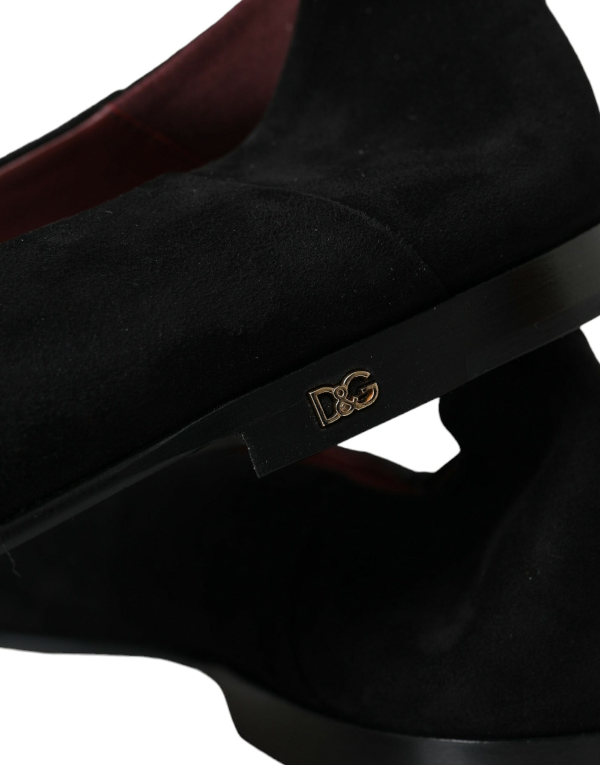 Pair of black suede boots with gold buckle and logo on side