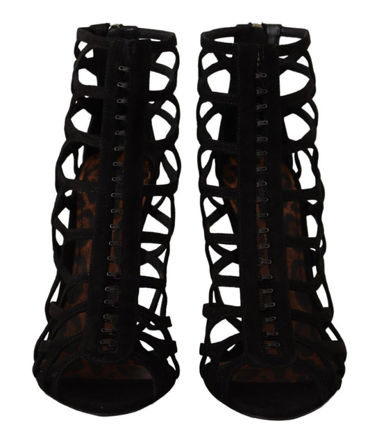 Pair of black high heel boots with lace up detailing and a patterned design on the sides