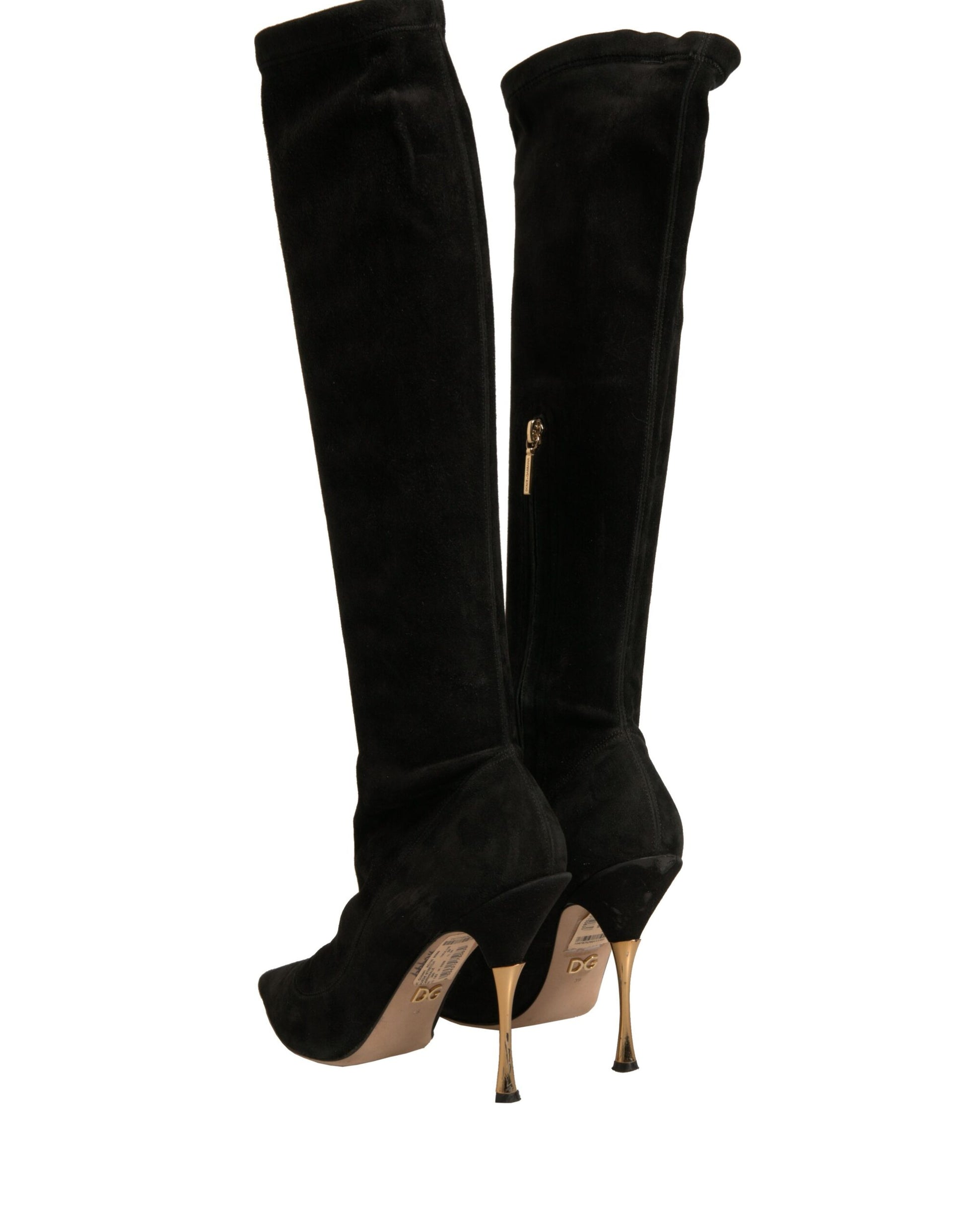 Pair of black knee high boots with gold heels