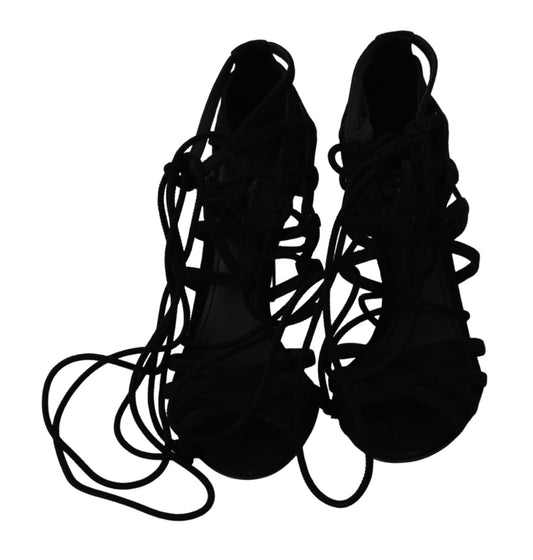 Pair of black high heel shoes with laces and straps