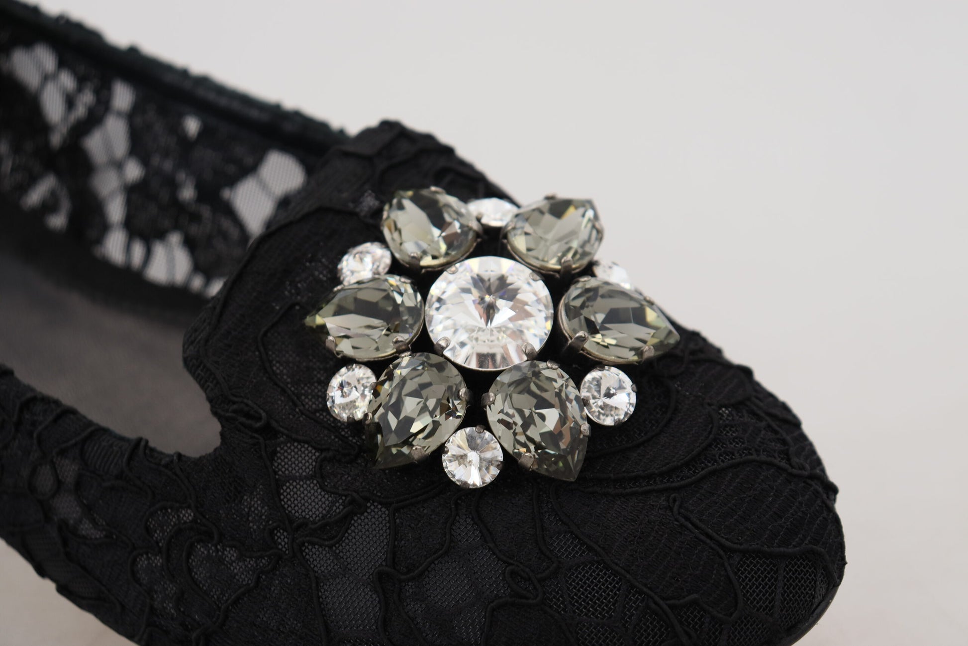 Black lace bra with a sparkling crystal brooch on it