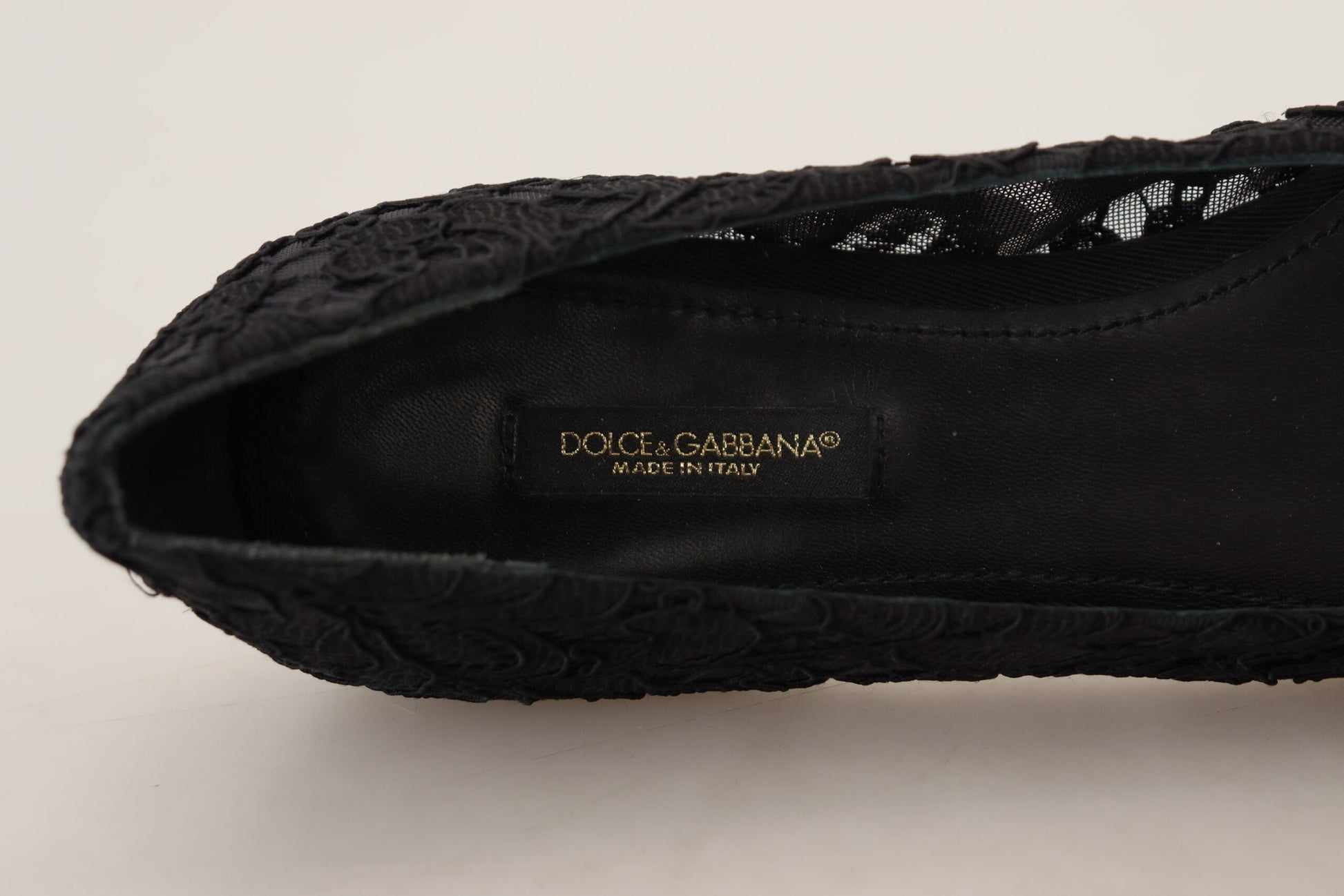 Black shoe with embossed logo and design details