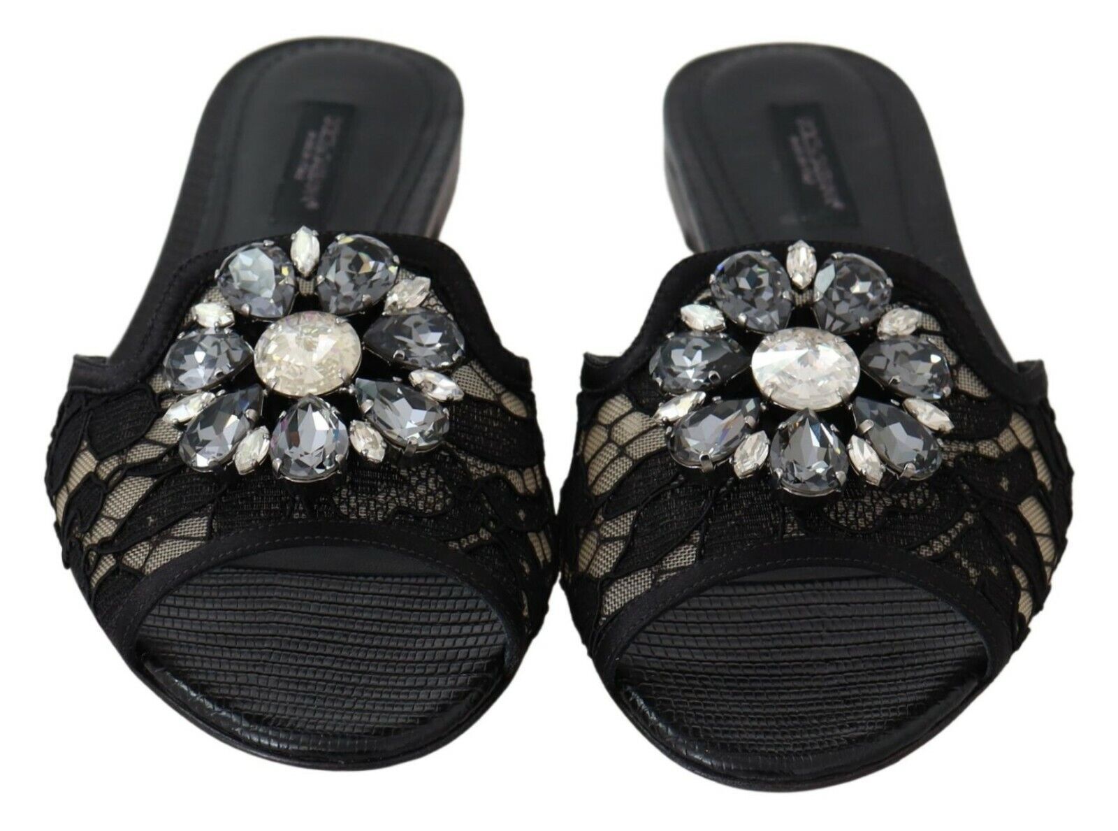 Pair of black women's sandals with embellished heels featuring multiple crystals and rhinestones