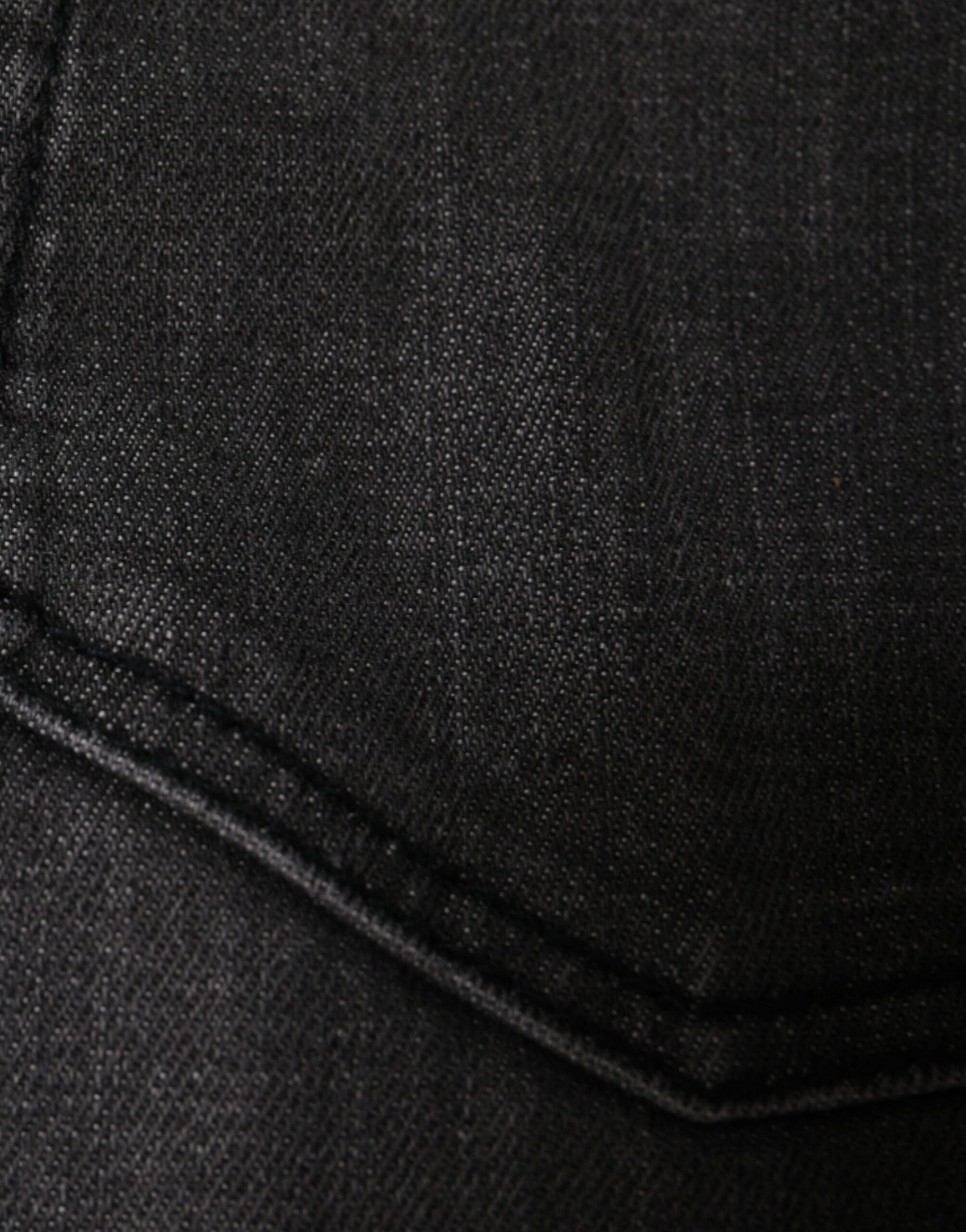Dark denim jeans with visible stitching on seams