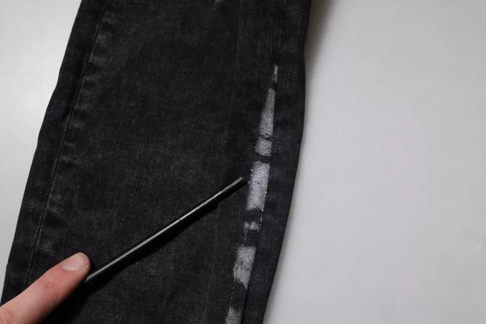 Pair of jeans on a table with a hand holding a pen