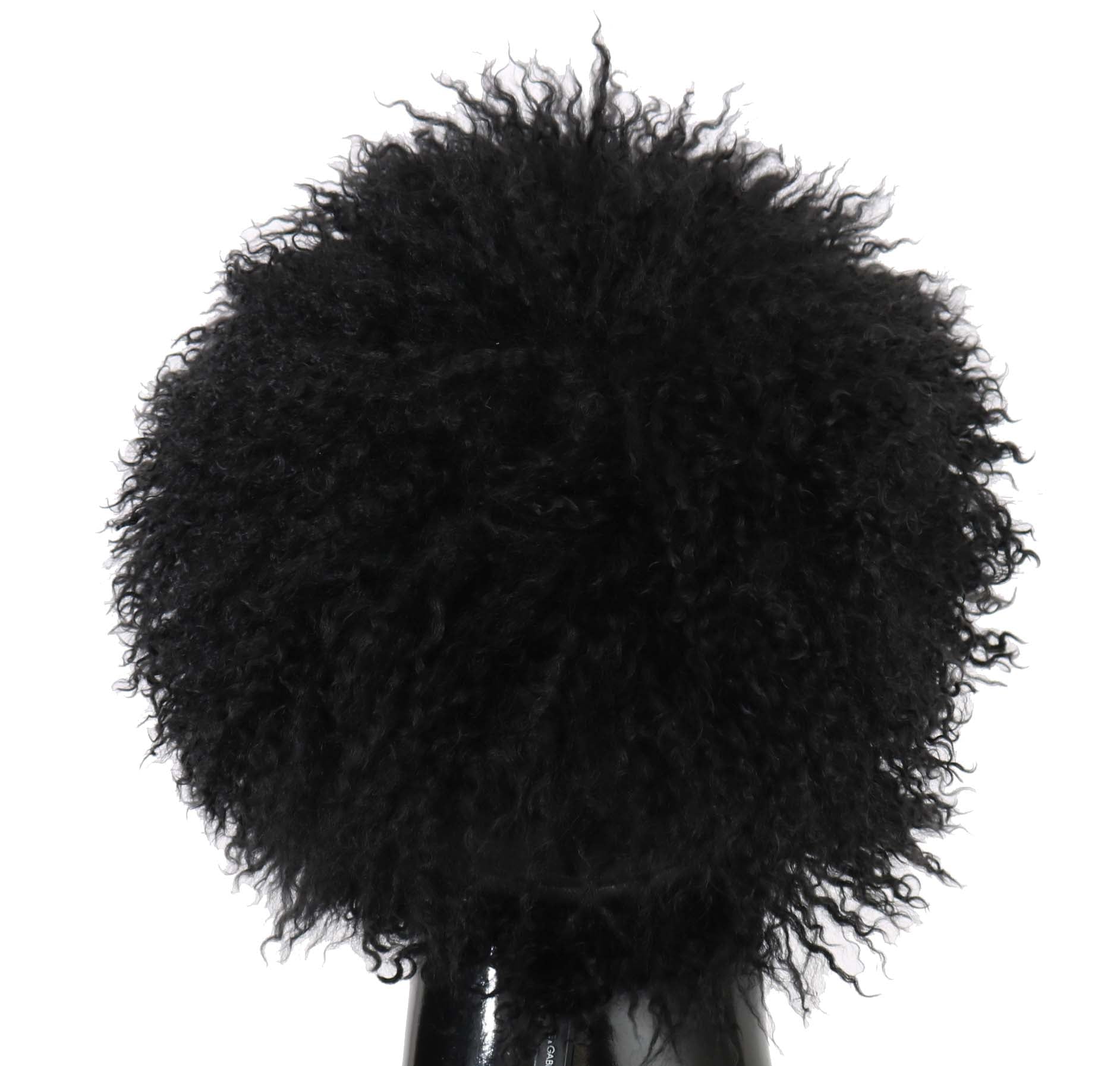 Black furry pom pom on top of a bottle