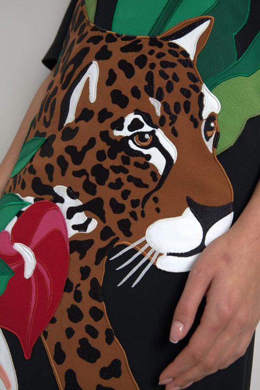 A black tiger print dress with a jungle theme, featuring a stretchy fabric and a sheath silhouette