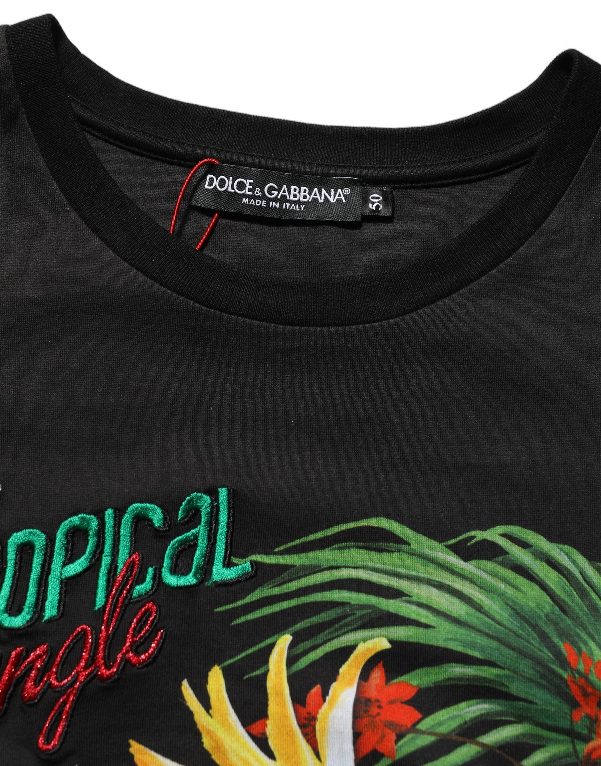A black t-shirt with a tropical jungle print and the text "POLAR BEAR" in red
