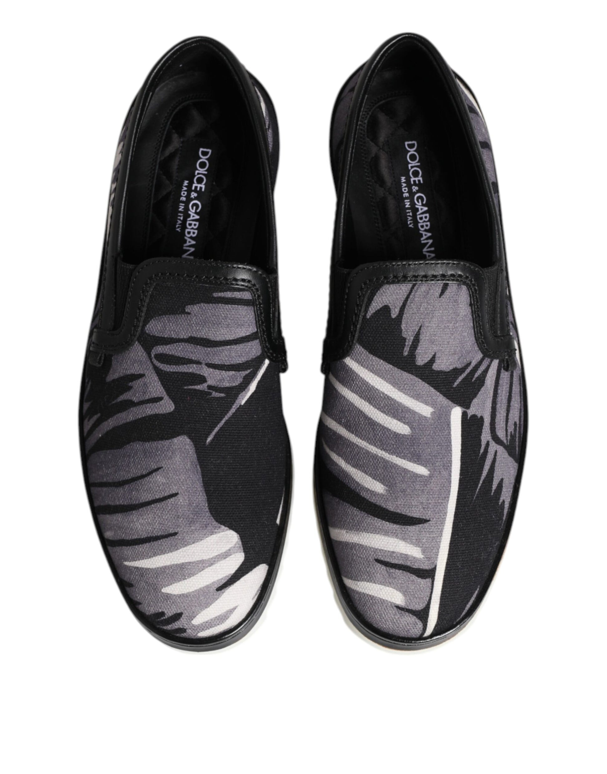 Pair of black shoes with white leaf pattern on soles