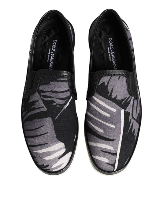 Pair of black shoes with white leaf pattern on soles
