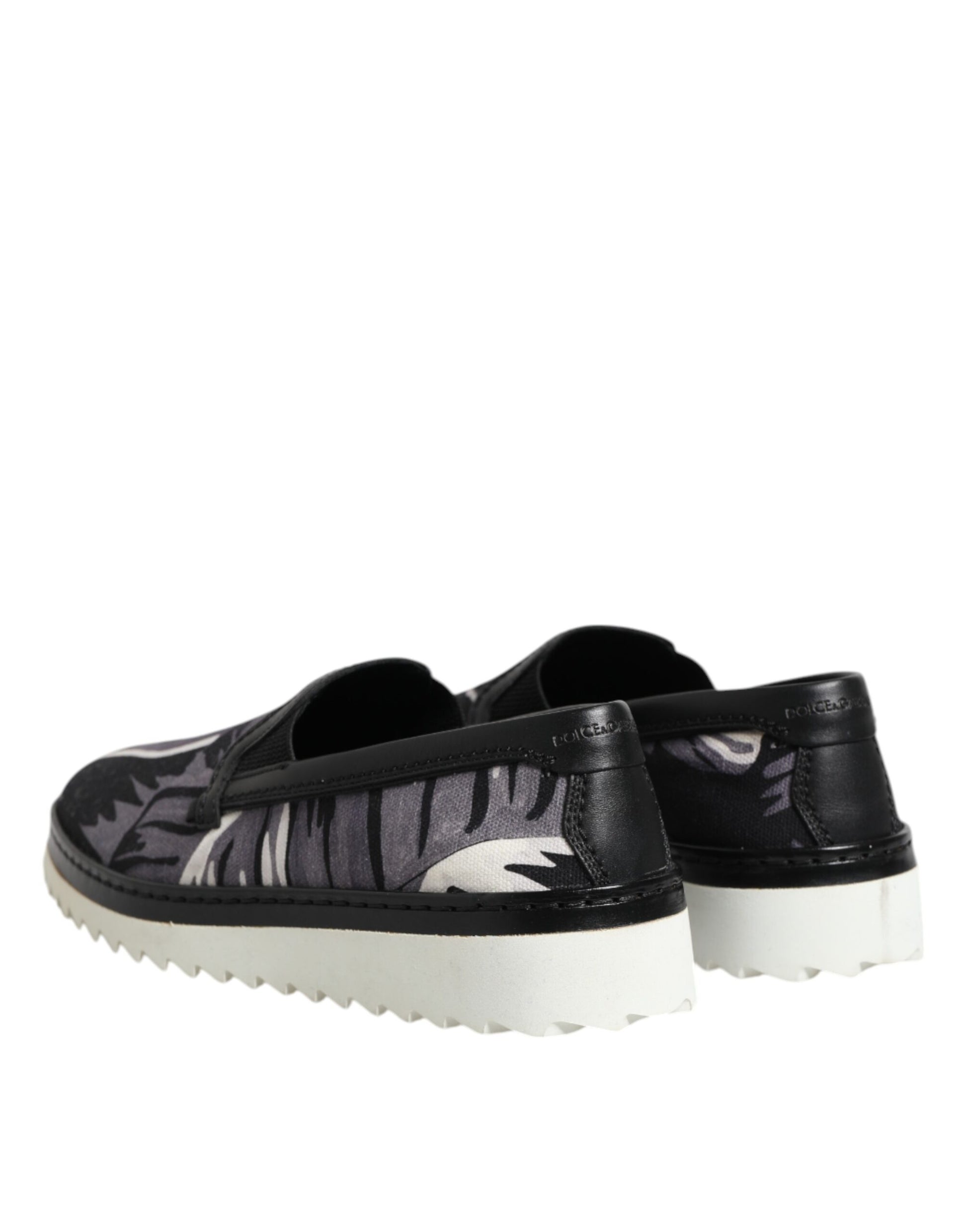 Pair of black shoes with white soles and patterned design on top