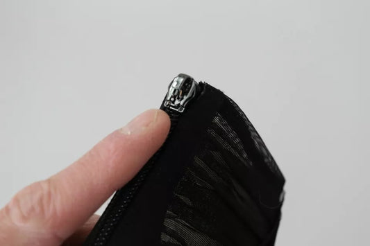 Hand holding fabric with zipper
