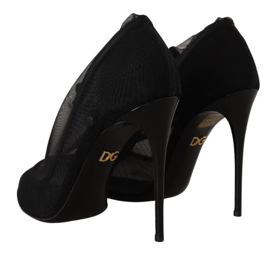 Pair of black high heel shoes with a glittery texture and gold lettering on the side