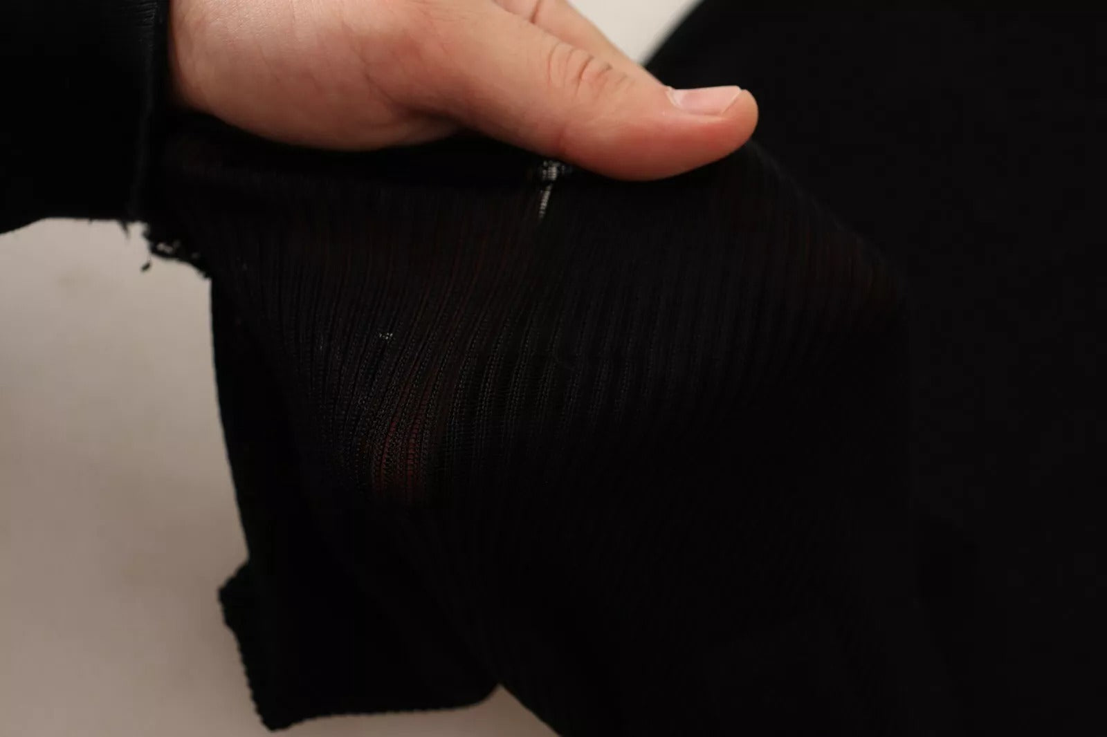 Hand holding black fabric