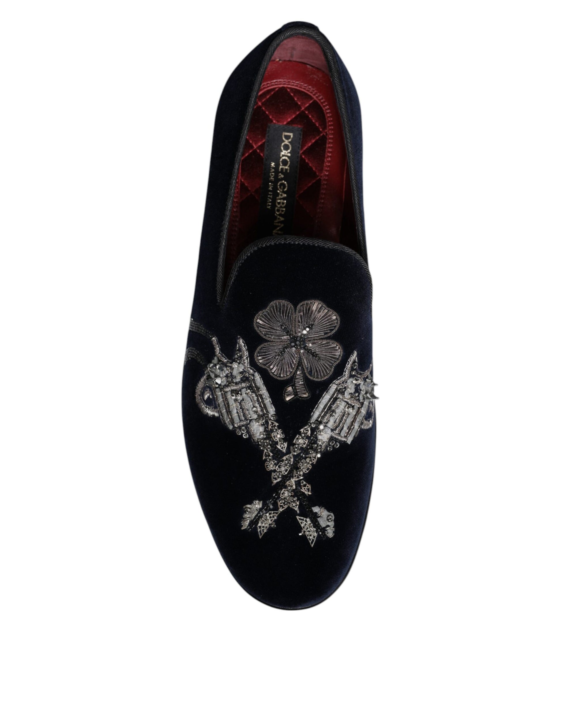 A pair of black velvet loafers with floral embroidery and silver buckle