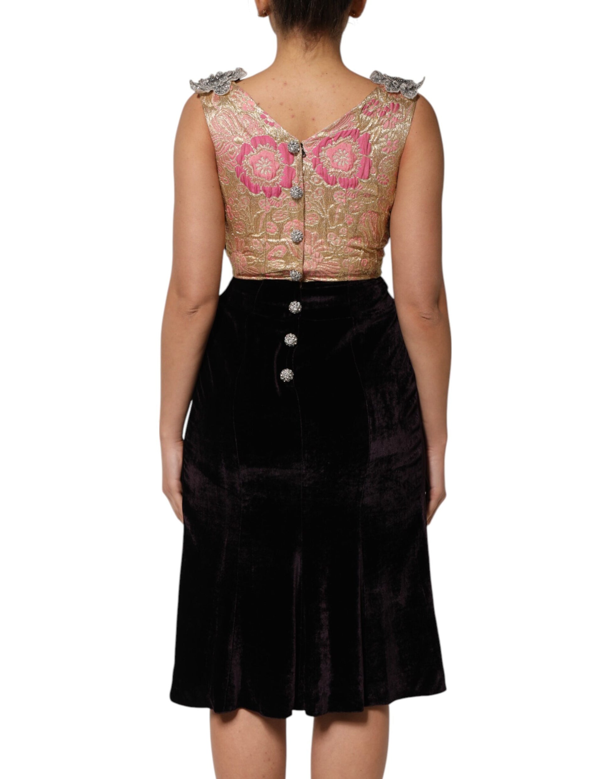 A black velvet dress with floral embellishments on the back and sleeves