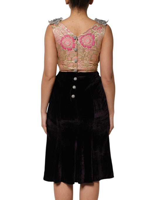 A black velvet dress with floral embellishments on the back and sleeves