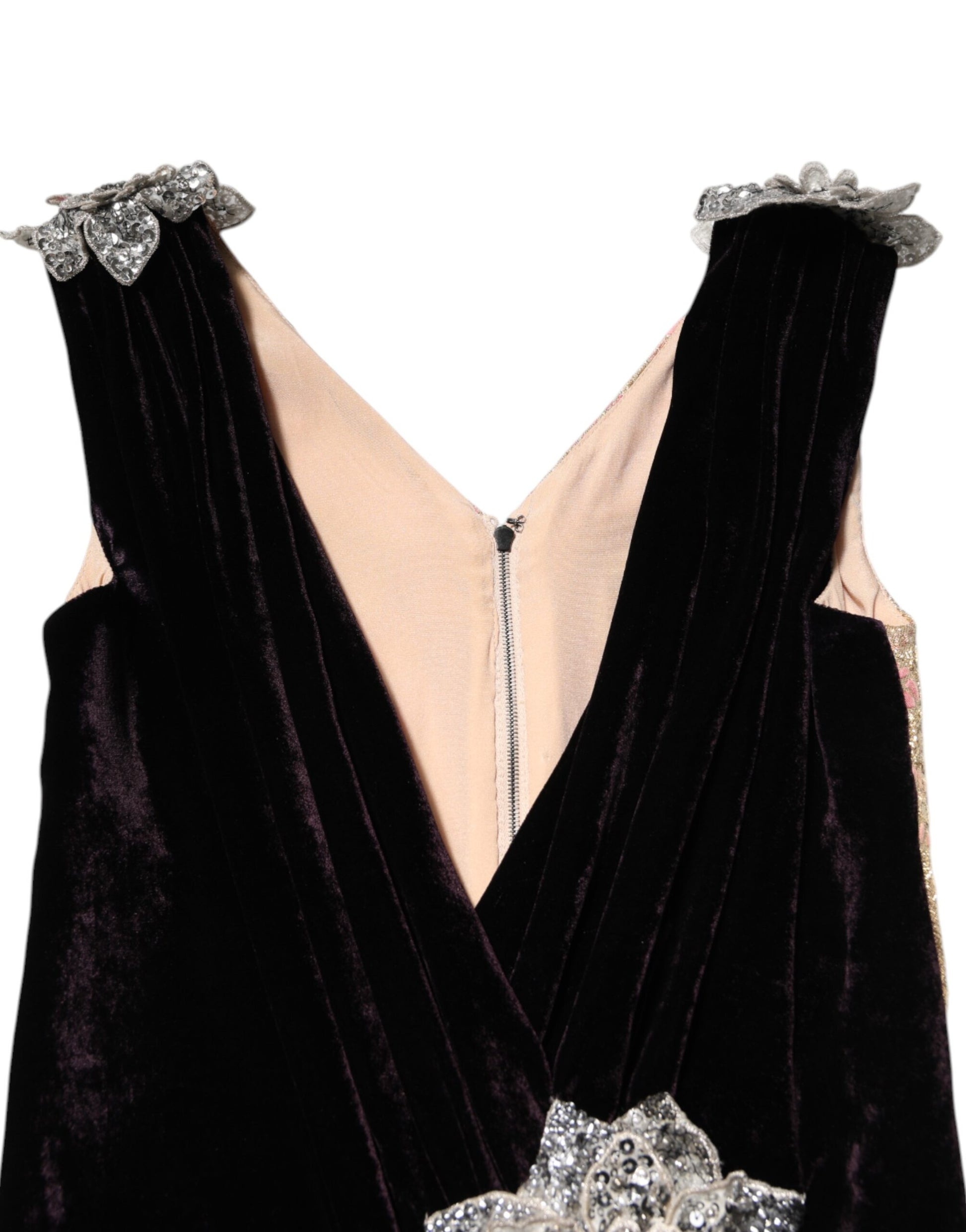 A black velvet dress with flower embellishments and a sheer panel at the front