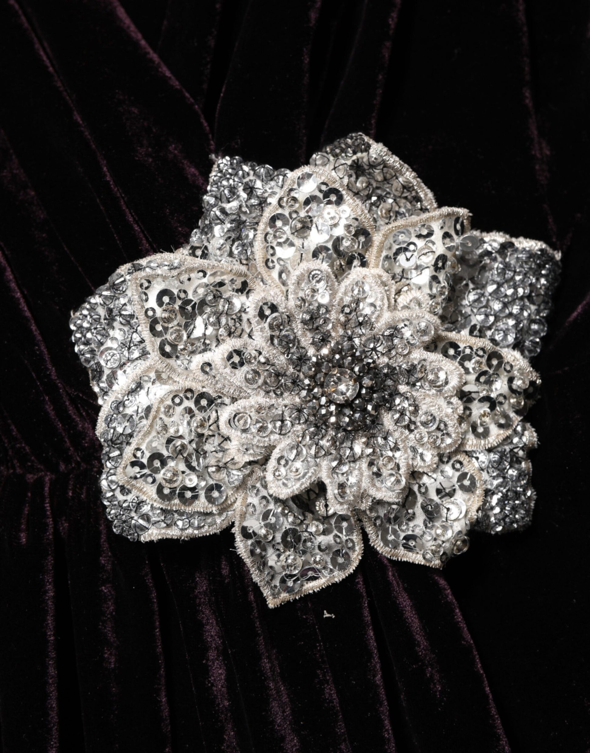 Silver flower embellishment on black velvet fabric