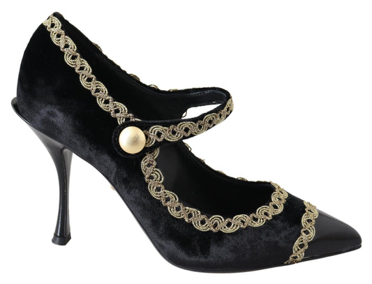 Black velvet high heel shoes with gold accents and a bow on the ankle