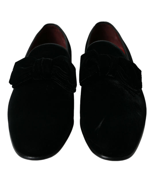 Pair of black shoes with red soles and laces