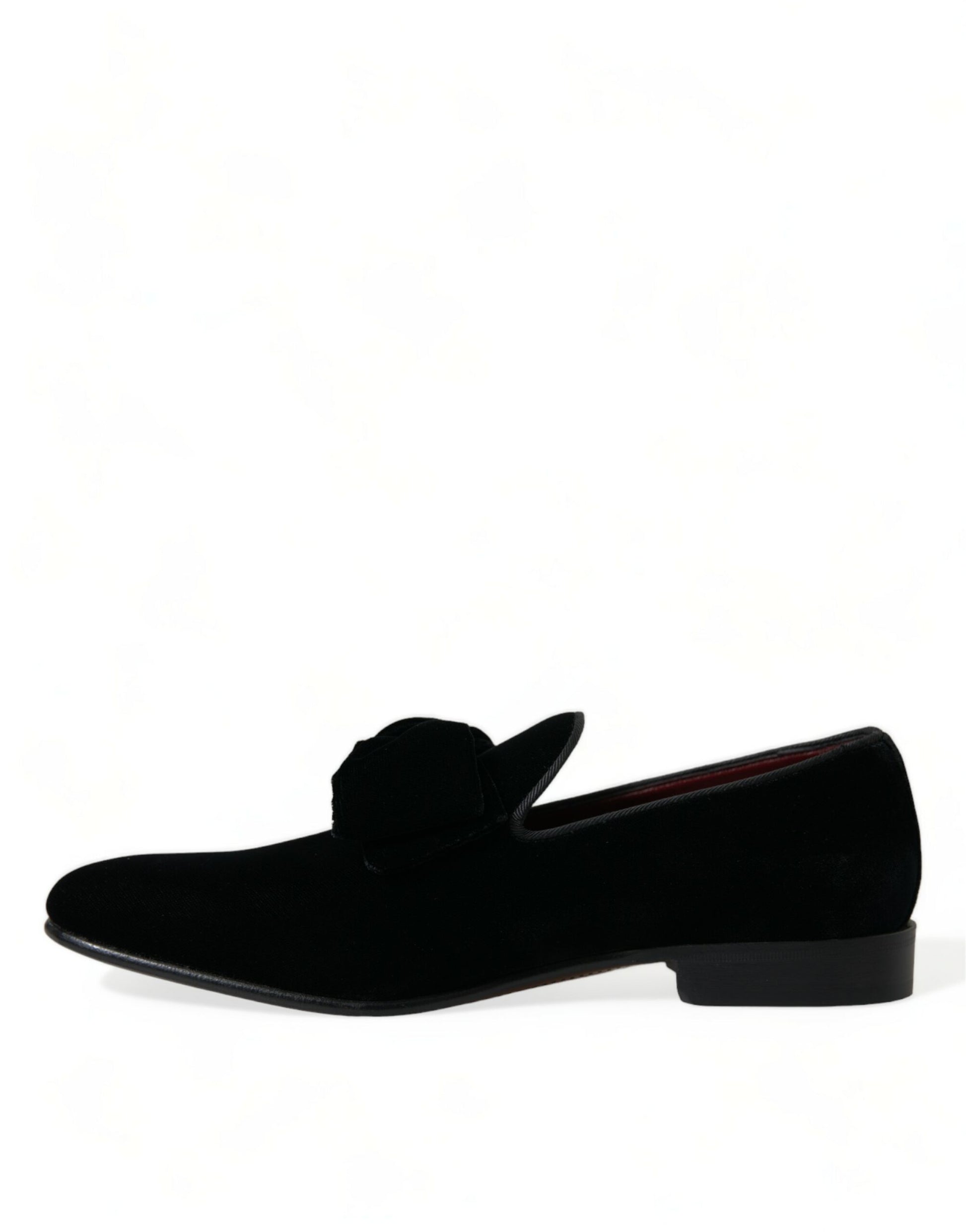 Pair of black velvet loafers with elastic panels and a bow on top