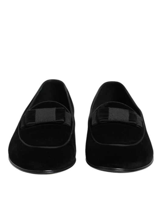 Pair of black velvet loafers with elastic panels and a bow tie