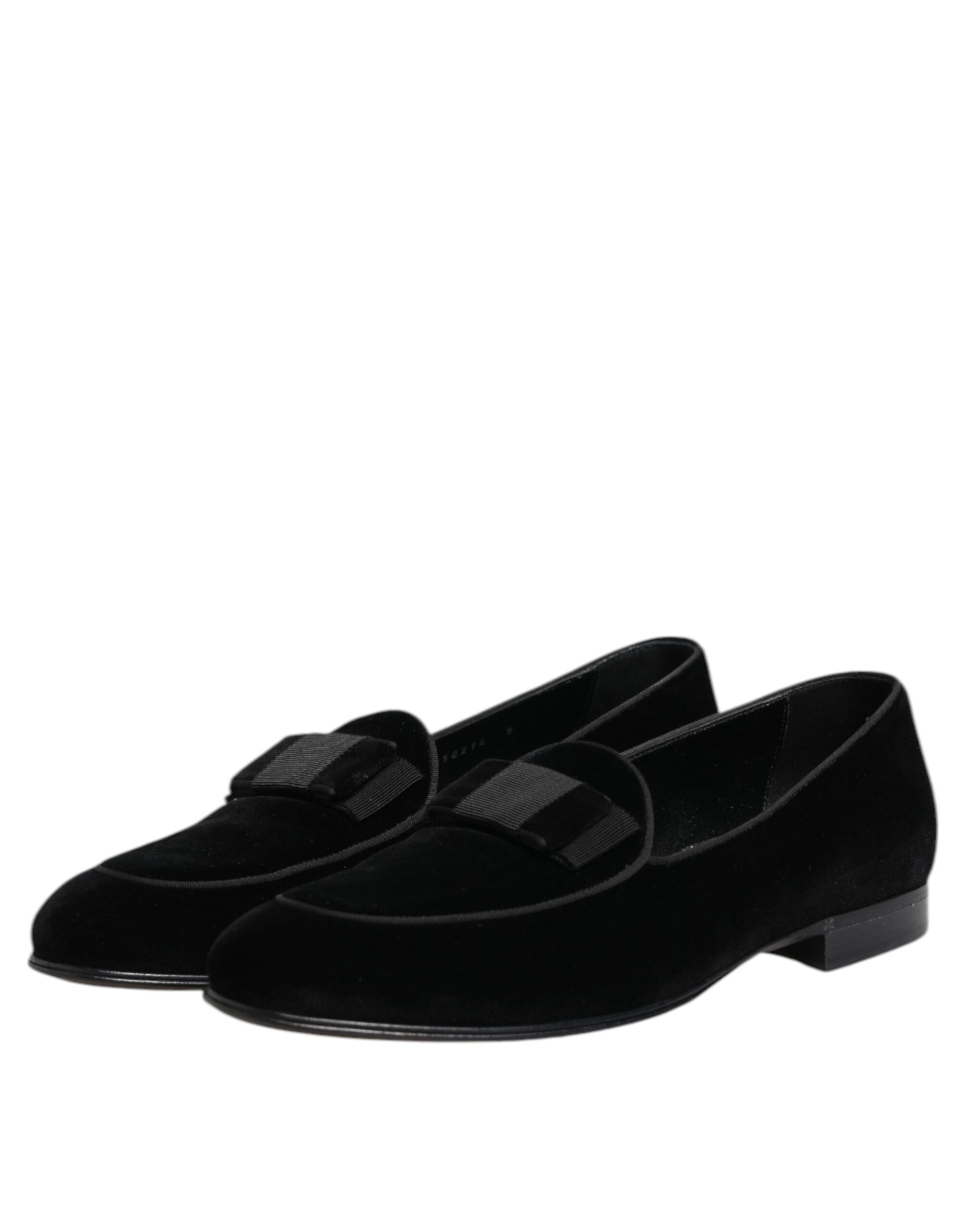Pair of black velvet loafers with elastic panels, featuring a textured design and a low heel