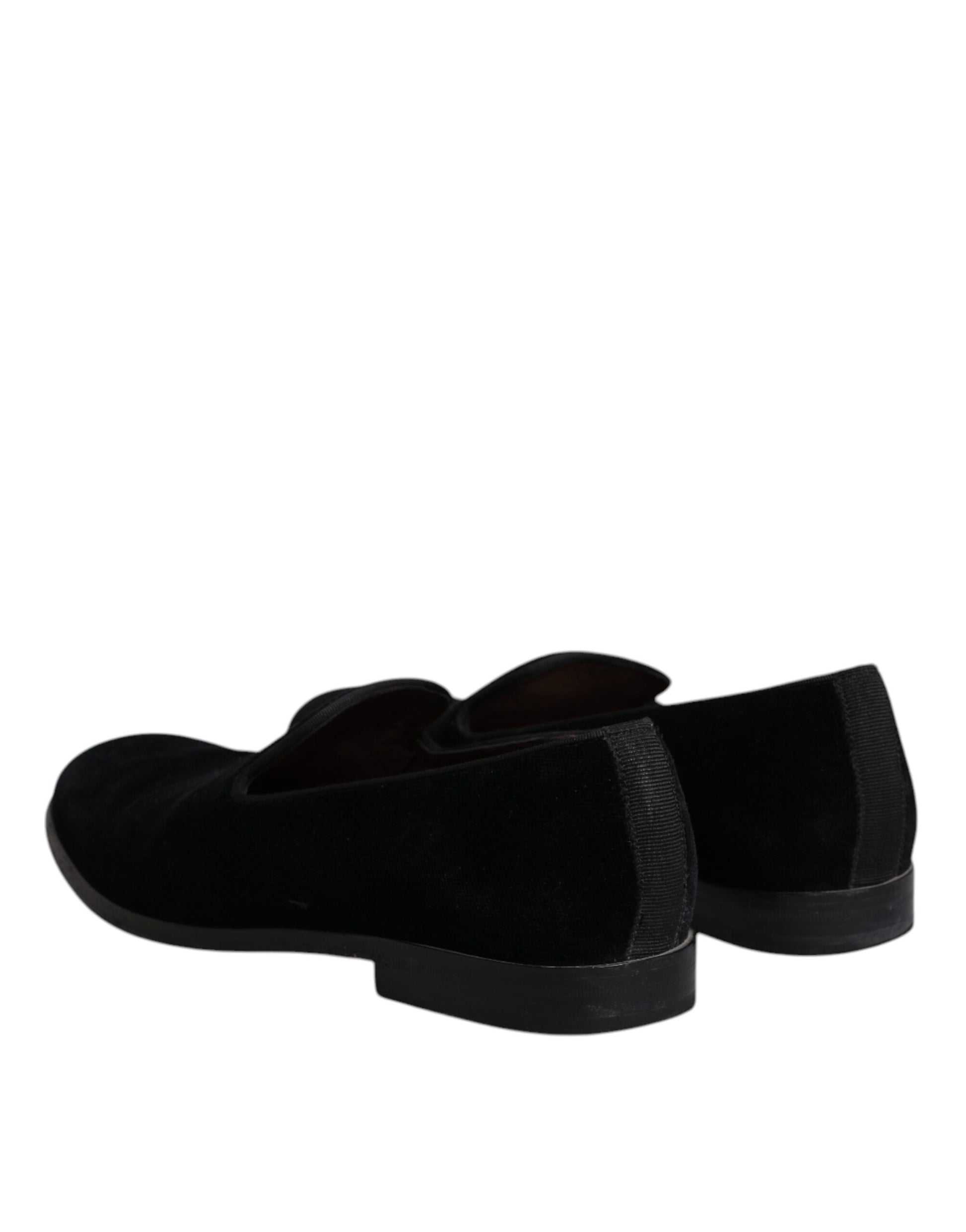Pair of black velvet loafers with a shiny finish, featuring a round toe and elastic panels for comfort