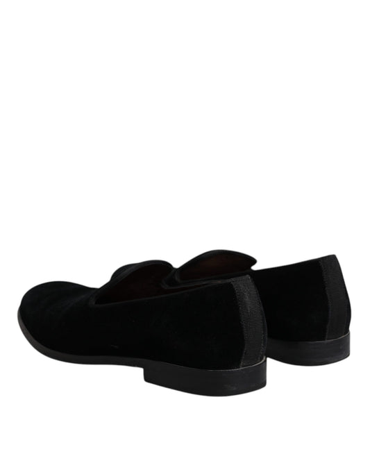 Pair of black velvet loafers with a shiny finish, featuring a round toe and elastic panels for comfort
