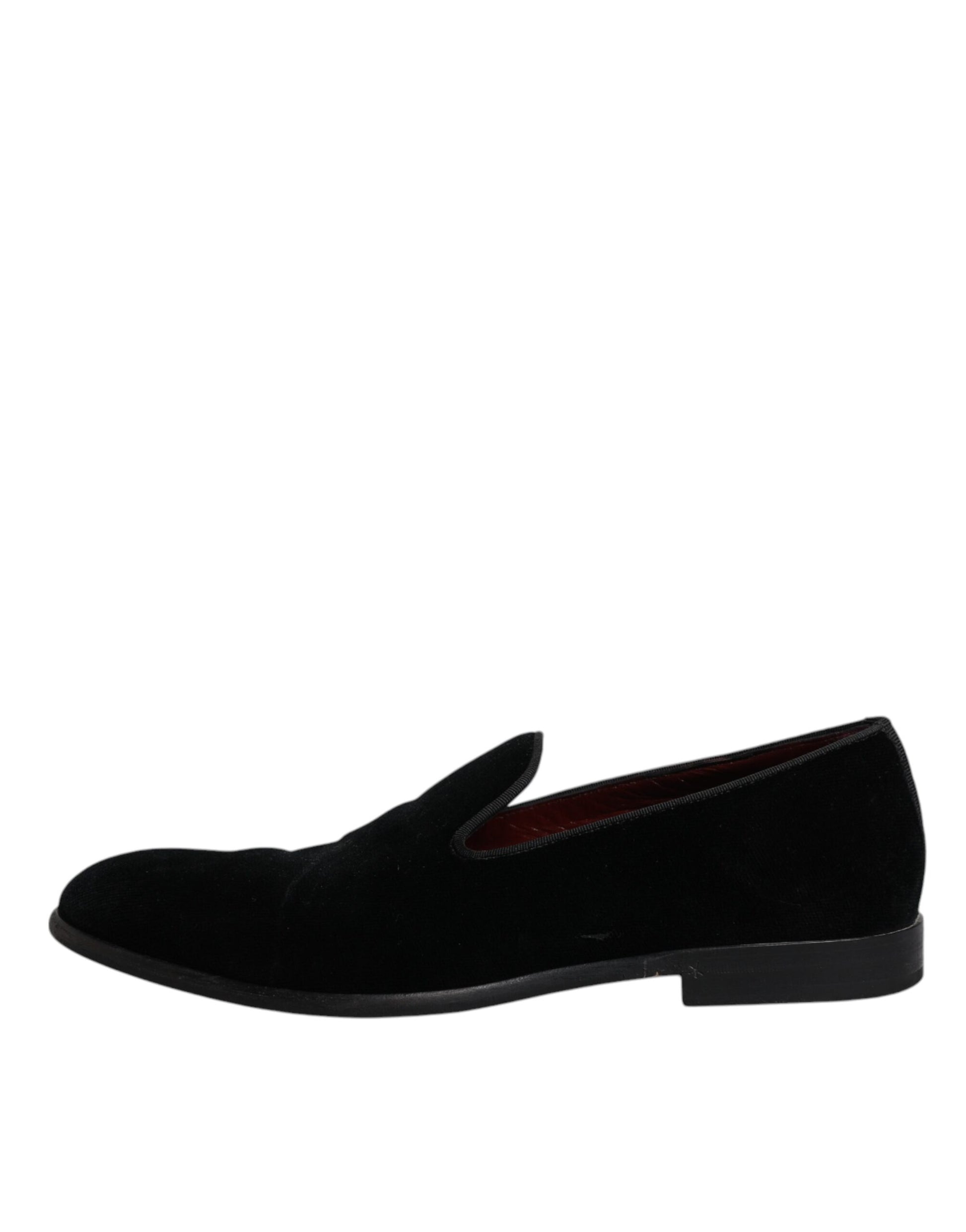 A pair of black velvet loafers with red accents, designed for formal men's wear