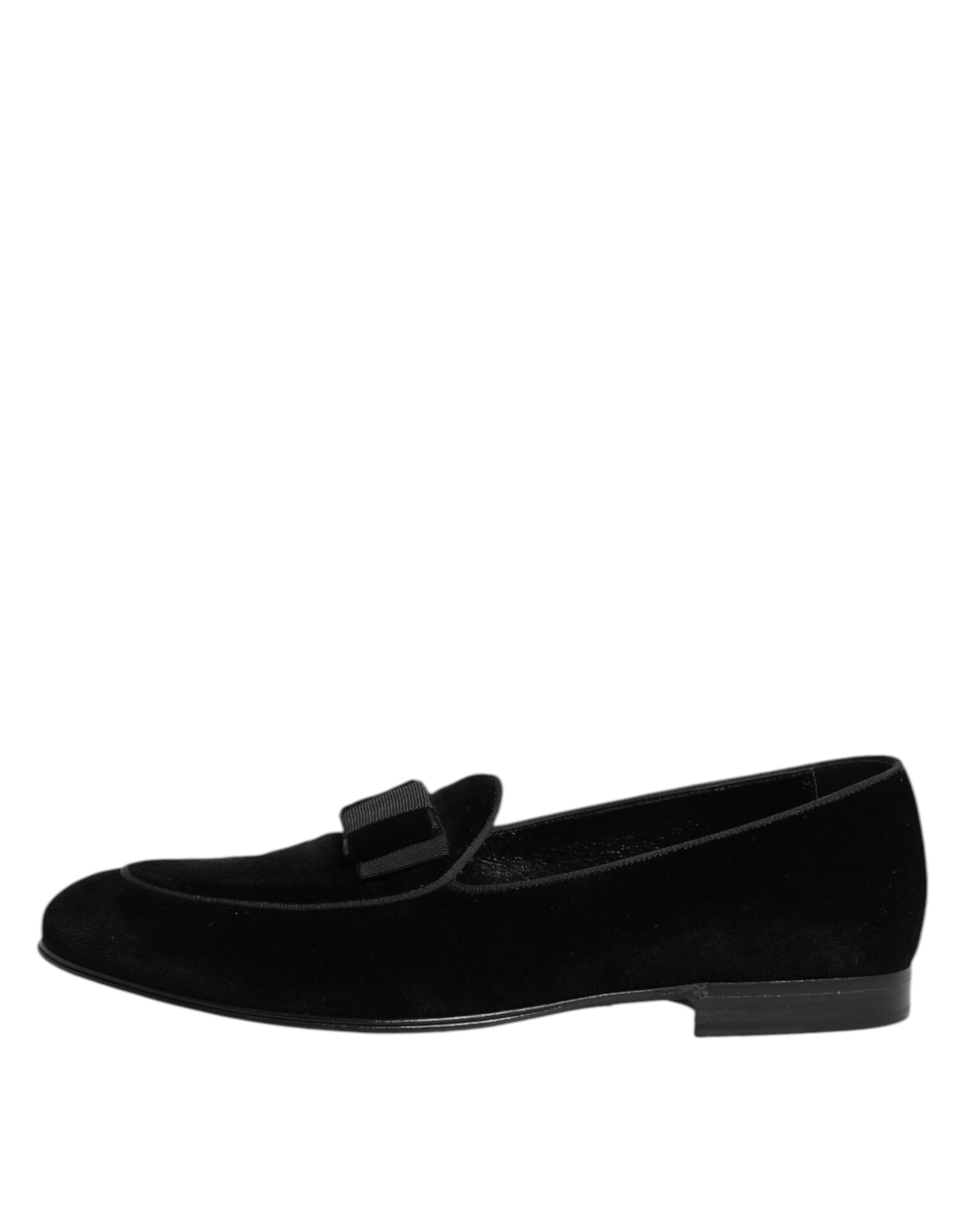 A pair of black velvet loafers with a buckle closure, designed for formal men's wear