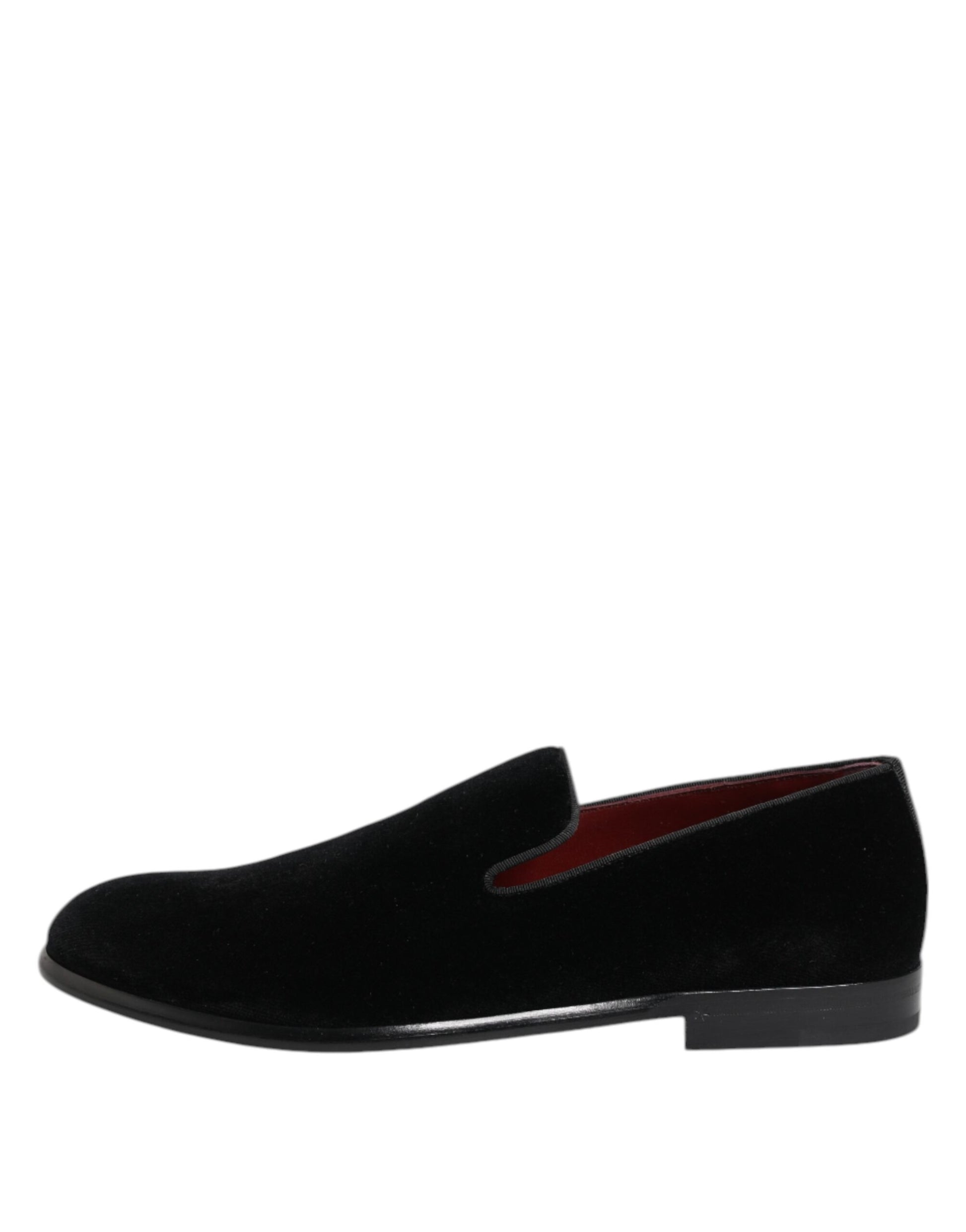 A pair of black velvet loafers with red accents, designed for formal men's wear