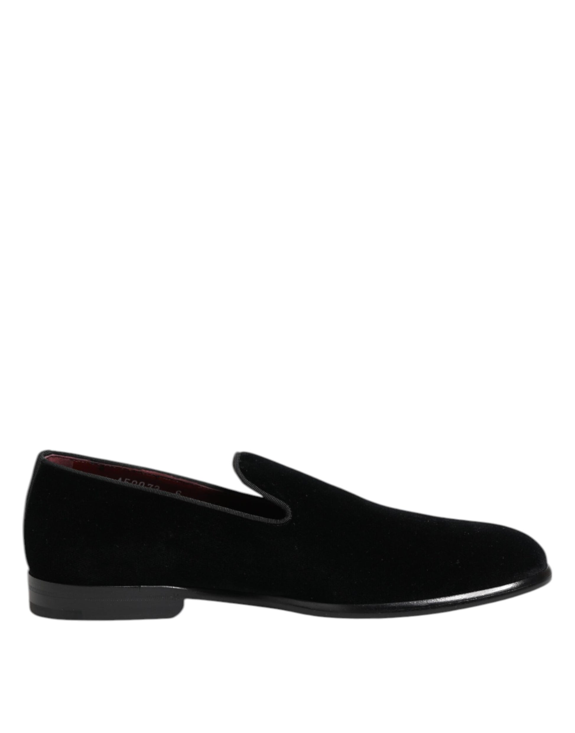 A pair of black velvet loafers with a red sole, designed for formal men's dress shoes