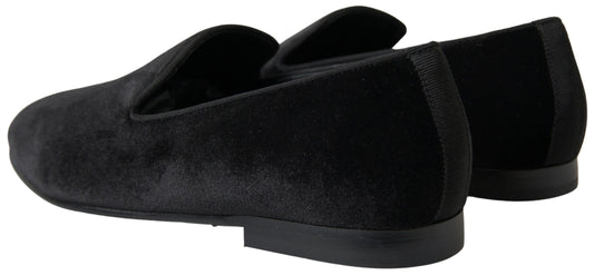 Pair of black velvet slippers with elastic panels and a flat sole