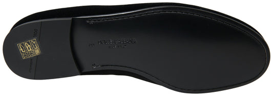 Black leather shoes with laces and a logo on the side