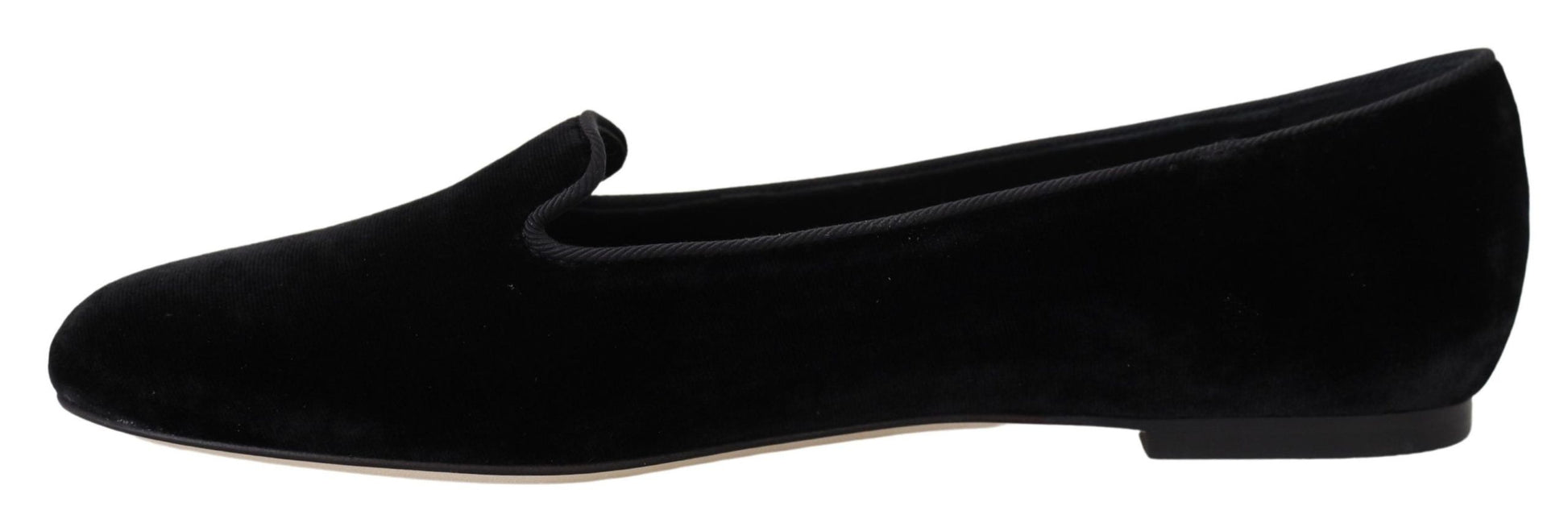 Pair of black velvet loafers with a tan sole