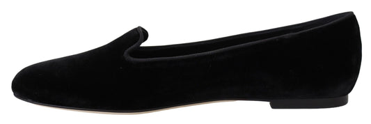 Pair of black velvet loafers with a tan sole
