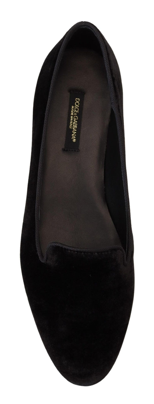 Pair of black velvet loafers with gold label on side